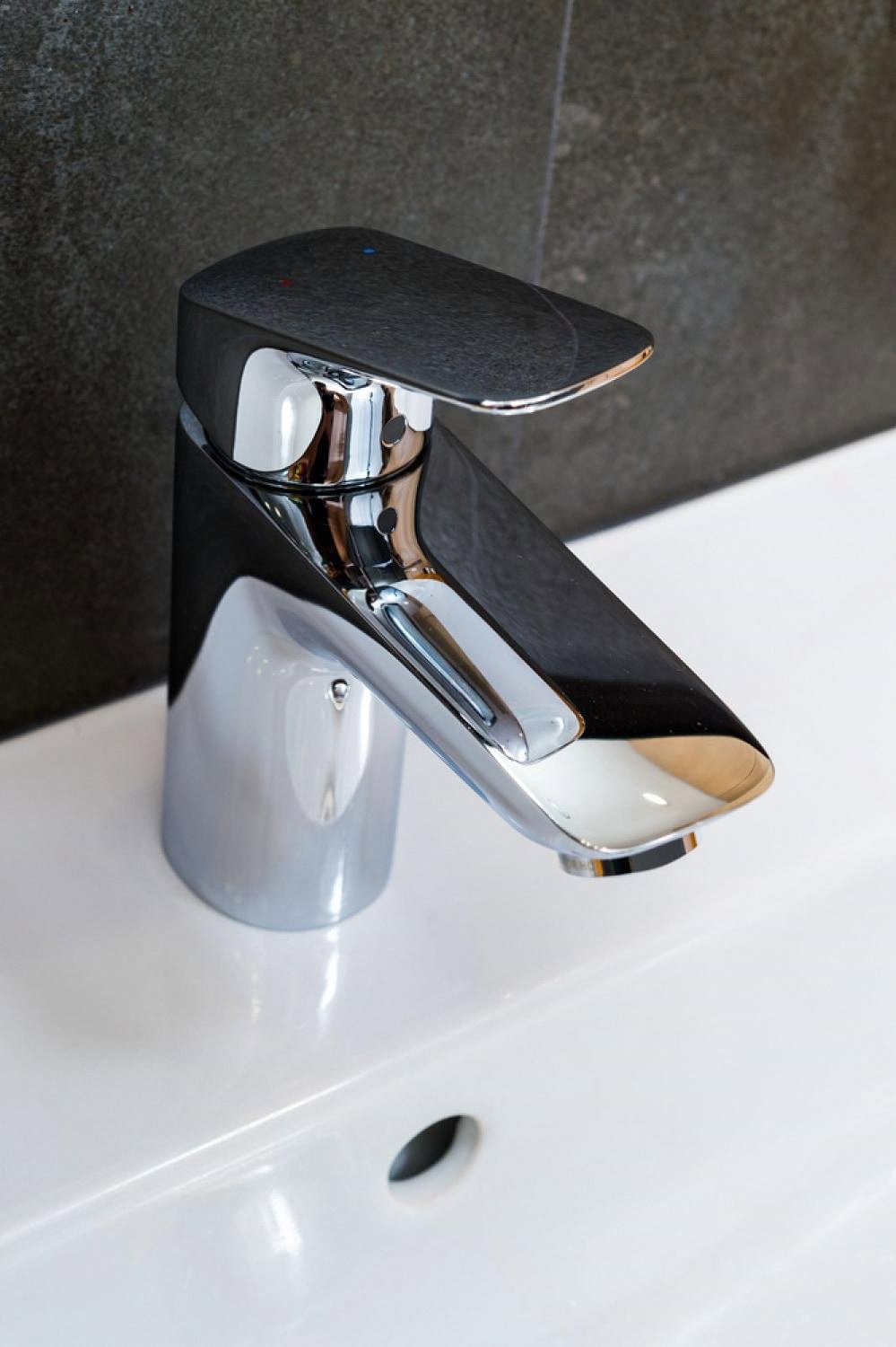 Modern chrome bathroom faucet on a white basin in a UAE apartment